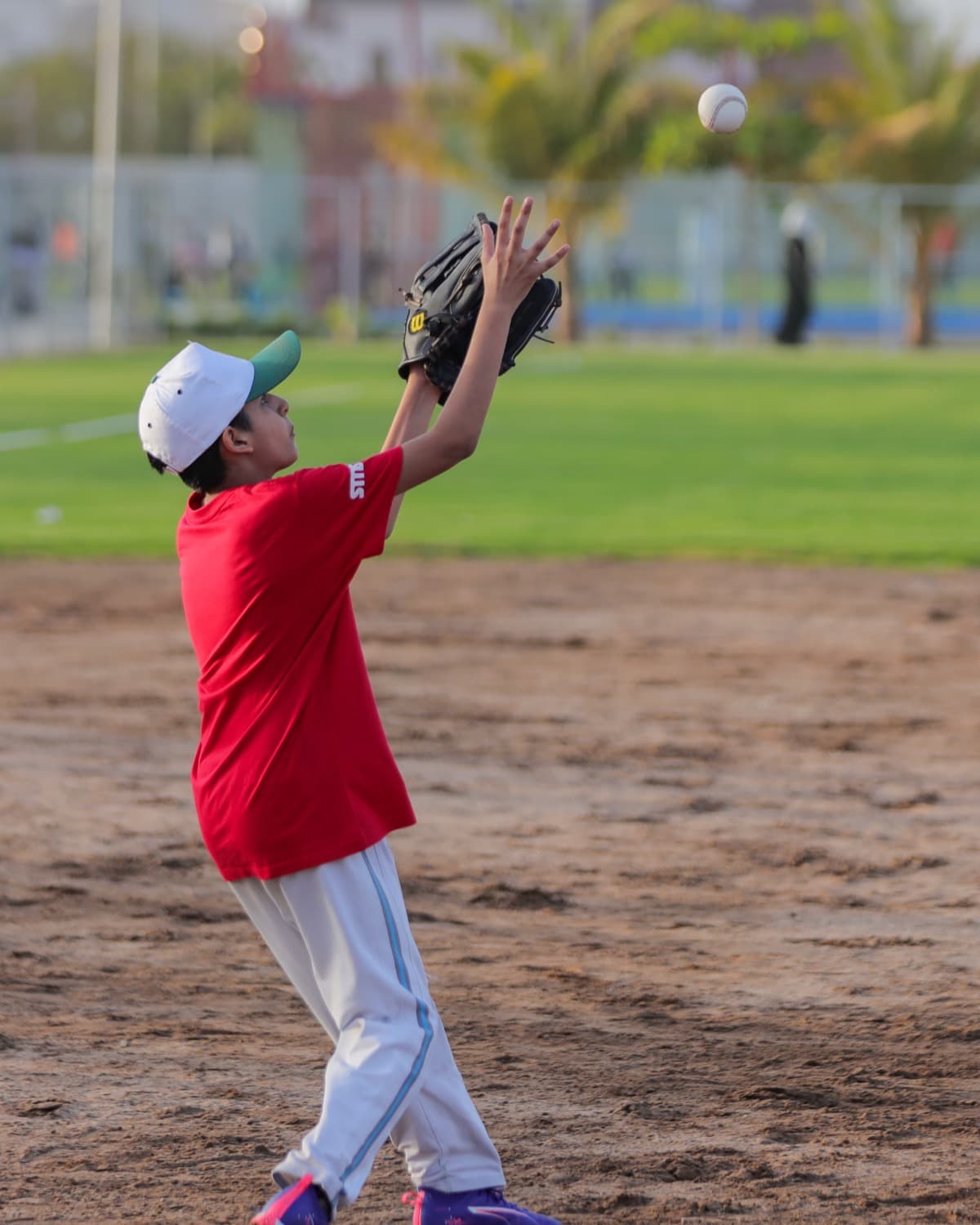 Young player catching a fly ball